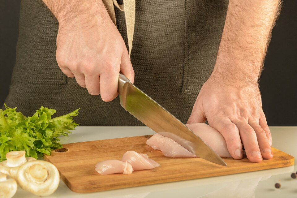 Chef preparing chicken cutlets in a modern kitchen