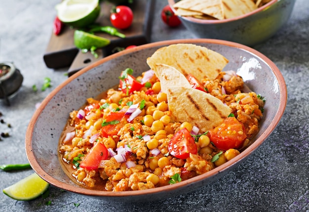  Colorful Mexican rice garnished with cilantro, bell peppers, and corn on a rustic wooden table